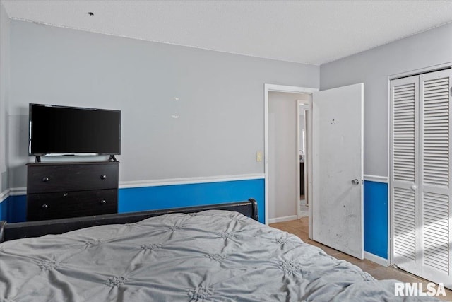 bedroom featuring a closet, tile patterned flooring, and baseboards