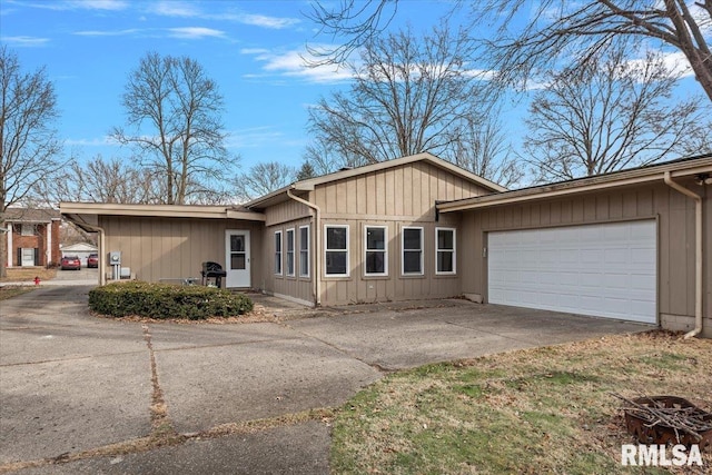 ranch-style house with a garage and driveway