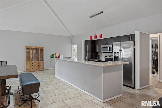 kitchen featuring light tile patterned floors, stainless steel appliances, visible vents, hanging light fixtures, and dark cabinetry