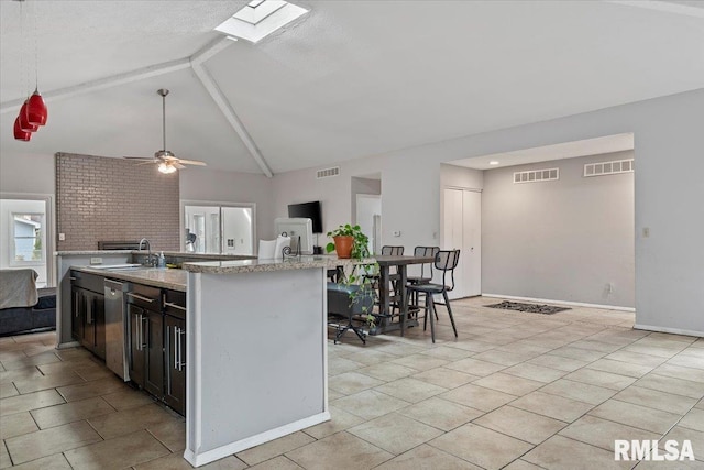 kitchen featuring open floor plan, visible vents, a sink, and stainless steel dishwasher