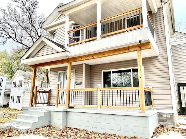 view of front facade featuring a balcony and covered porch