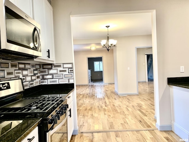 kitchen featuring stainless steel appliances, tasteful backsplash, light wood-type flooring, and white cabinets