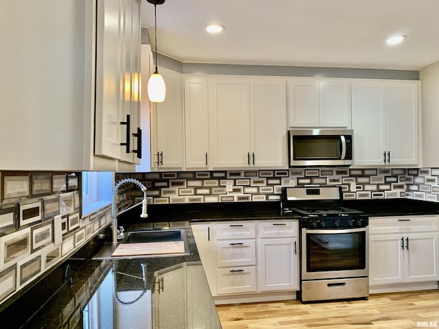 kitchen featuring white cabinetry, appliances with stainless steel finishes, and a sink