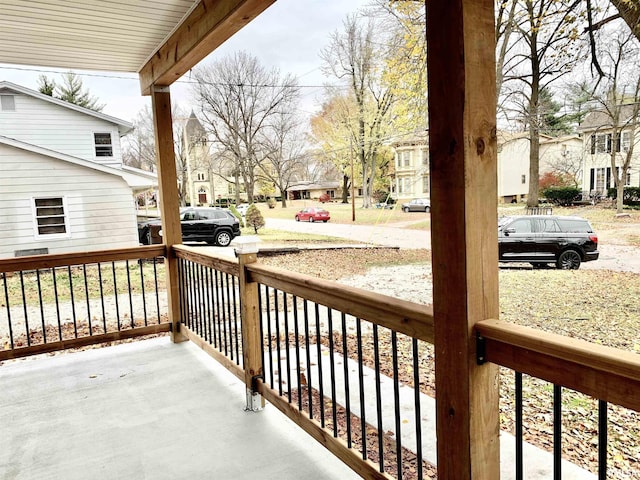 wooden deck with covered porch and a residential view