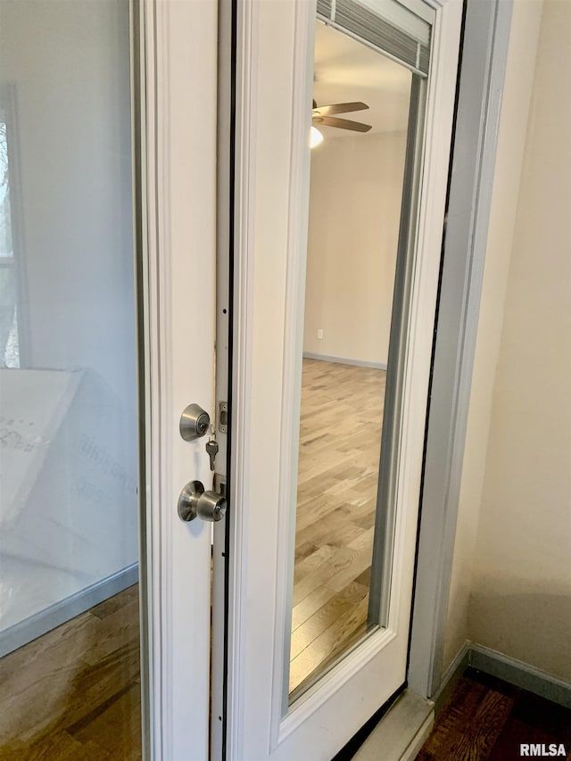 details featuring ceiling fan, baseboards, and wood finished floors