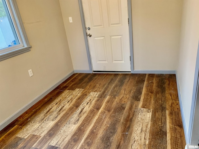 unfurnished room with wood finished floors and baseboards