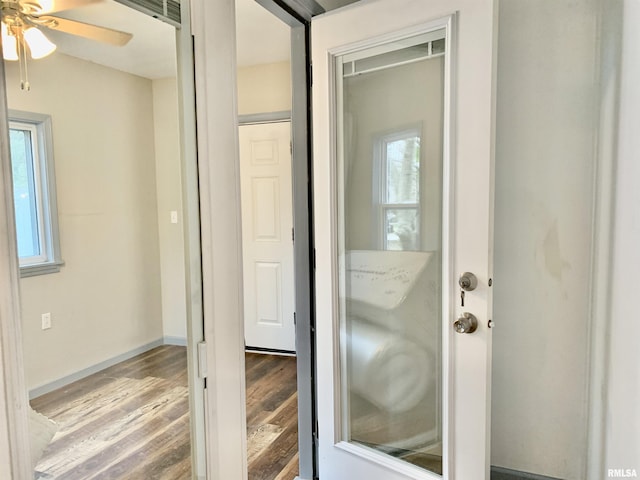 bathroom with ceiling fan, baseboards, and wood finished floors