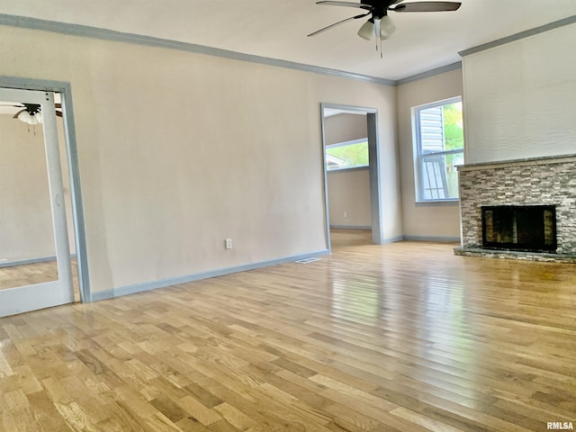 unfurnished living room with ornamental molding, ceiling fan, and light wood finished floors