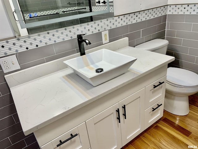 bathroom featuring wood finished floors, vanity, and toilet