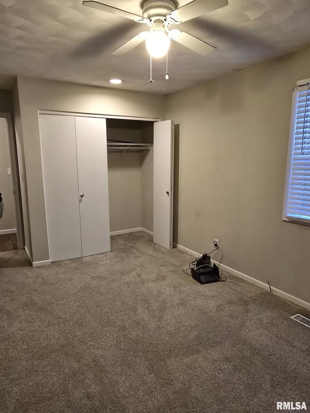 unfurnished bedroom with light colored carpet, a closet, visible vents, and baseboards