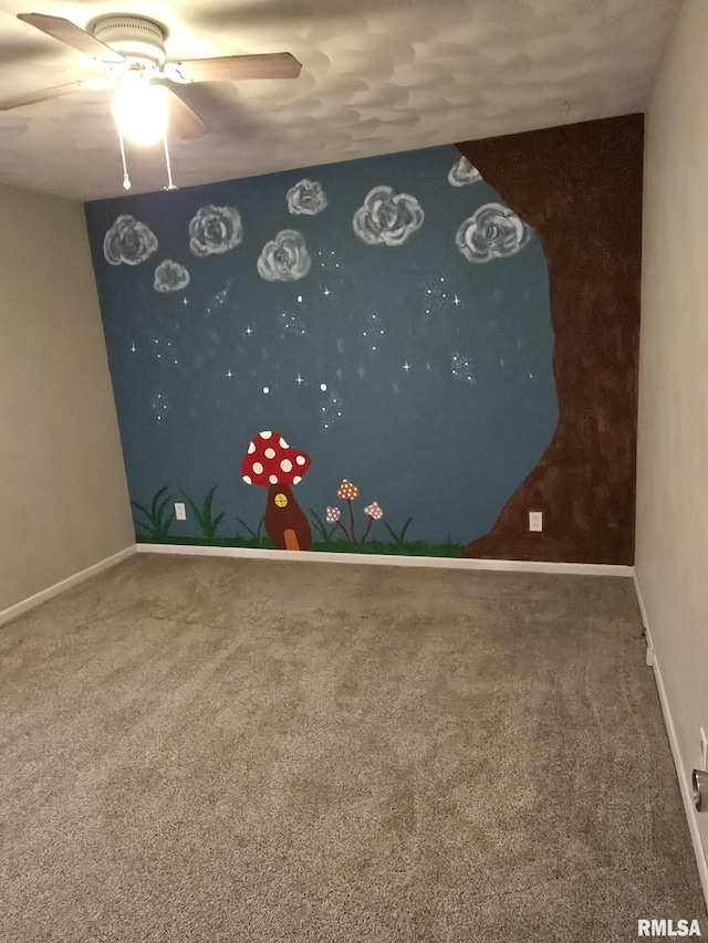 spare room featuring baseboards, a ceiling fan, and carpet flooring