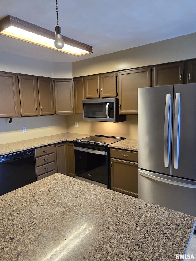 kitchen featuring dark stone counters and stainless steel appliances