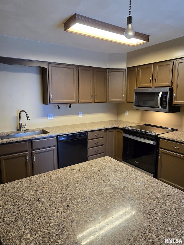 kitchen with black dishwasher, dark stone counters, electric range oven, stainless steel microwave, and a sink