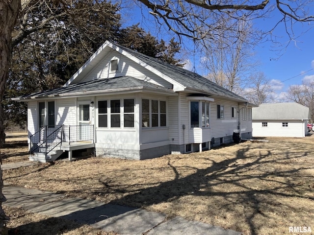 bungalow-style house with a shingled roof