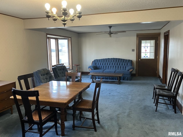 carpeted dining area with crown molding, ceiling fan with notable chandelier, and a healthy amount of sunlight