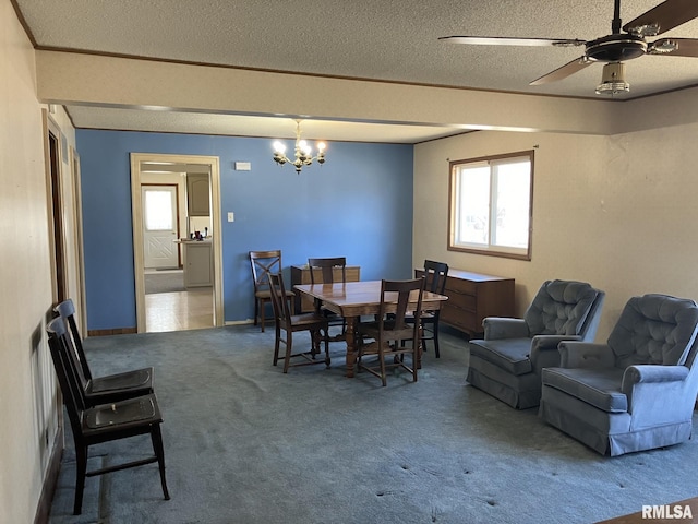 dining area featuring carpet, baseboards, a textured ceiling, and ceiling fan with notable chandelier