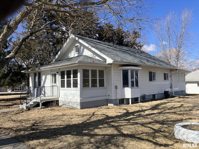 view of property exterior featuring a shingled roof