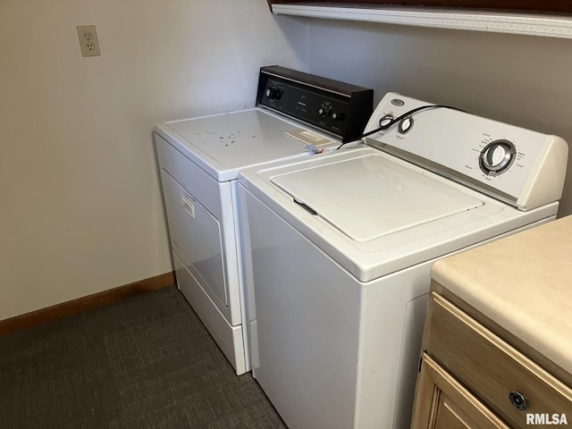 washroom with cabinet space, washer and clothes dryer, and baseboards