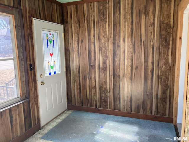 foyer with wooden walls