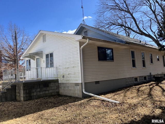 view of side of property featuring central AC unit and crawl space