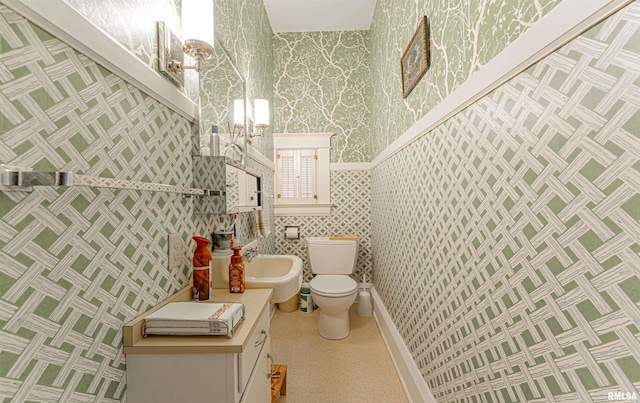 half bathroom featuring vanity, toilet, and wallpapered walls