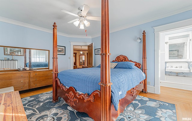 bedroom featuring ornamental molding and wood finished floors