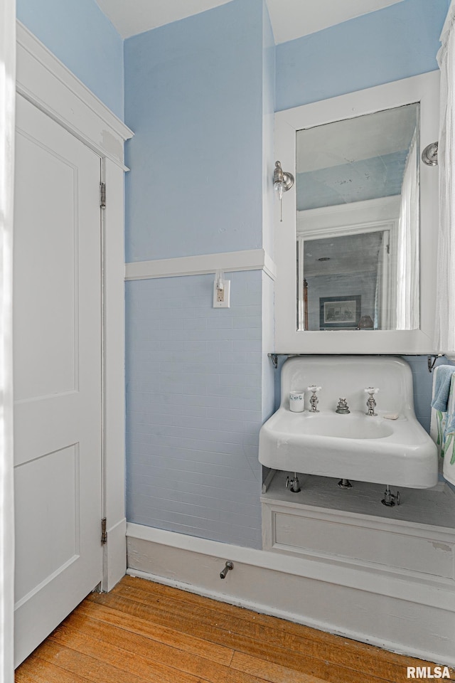 bathroom featuring a sink and wood finished floors