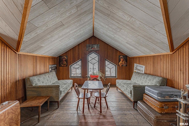 sitting room with vaulted ceiling, wood walls, and hardwood / wood-style flooring