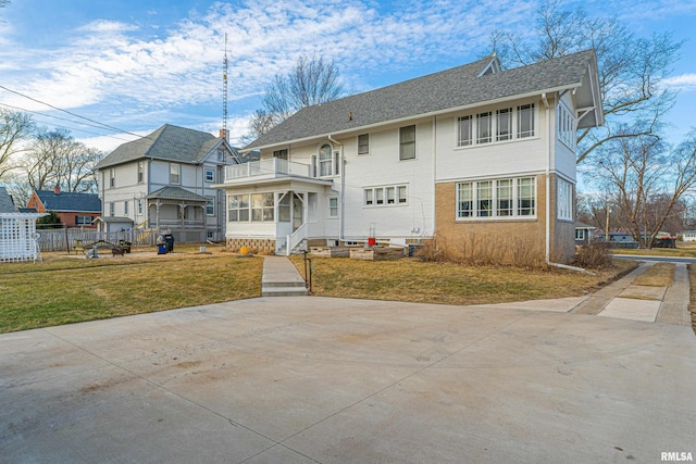 back of property with a lawn, fence, and a sunroom