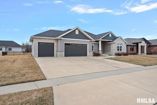 view of front of house with stone siding, an attached garage, driveway, and a front lawn