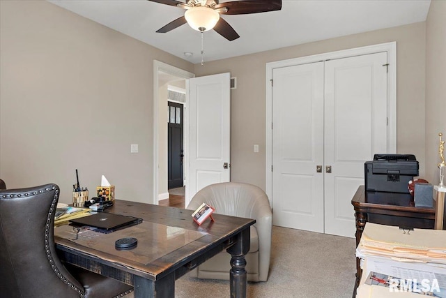 carpeted office space with ceiling fan