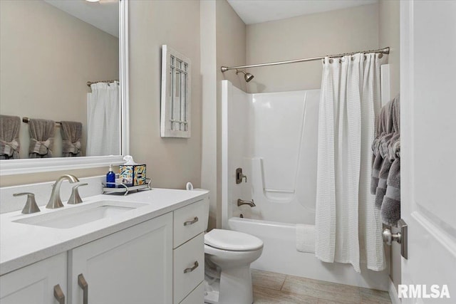 full bathroom with toilet, shower / bath combo with shower curtain, and vanity