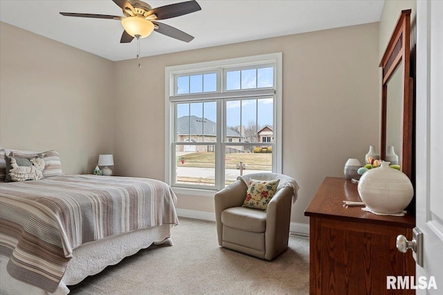 bedroom with light carpet, baseboards, and a ceiling fan