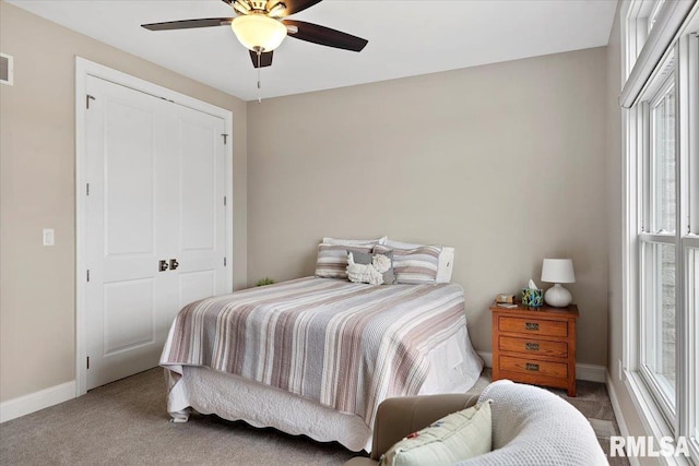 bedroom with visible vents, carpet flooring, a ceiling fan, and baseboards