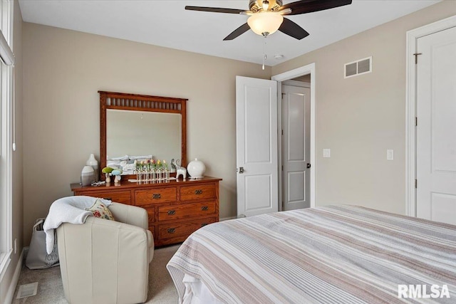 carpeted bedroom with ceiling fan and visible vents