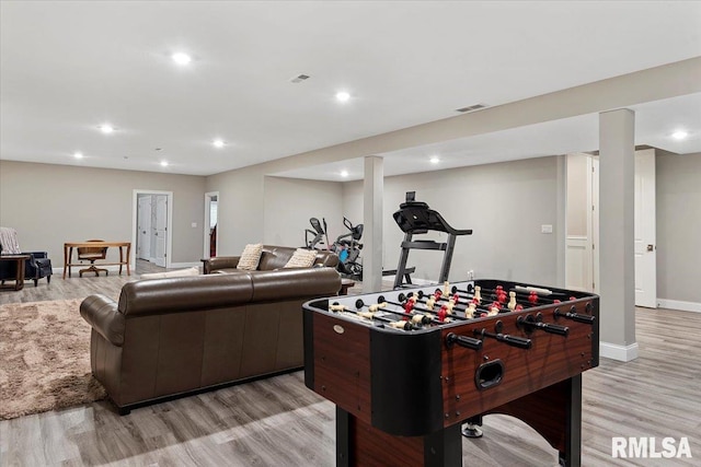 rec room with recessed lighting, baseboards, visible vents, and light wood finished floors