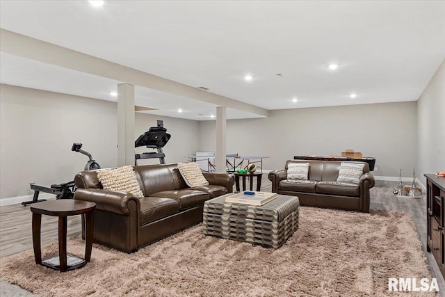 living room featuring baseboards, wood finished floors, and recessed lighting