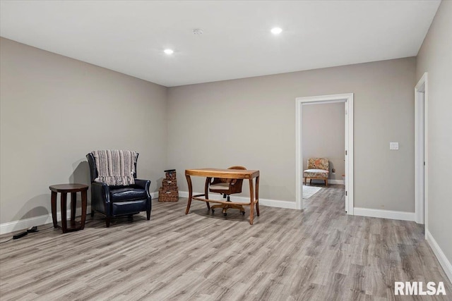 living area with recessed lighting, baseboards, and light wood finished floors