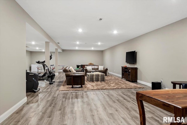 living area with light wood finished floors, baseboards, and recessed lighting