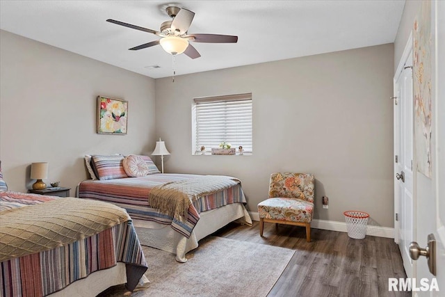 bedroom with visible vents, ceiling fan, baseboards, and wood finished floors