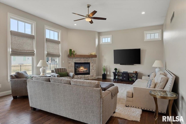 living room featuring recessed lighting, dark wood finished floors, visible vents, and baseboards