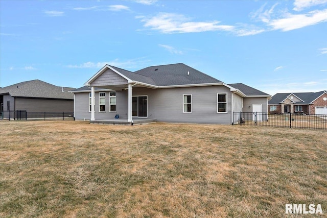 back of property with a fenced backyard and a lawn