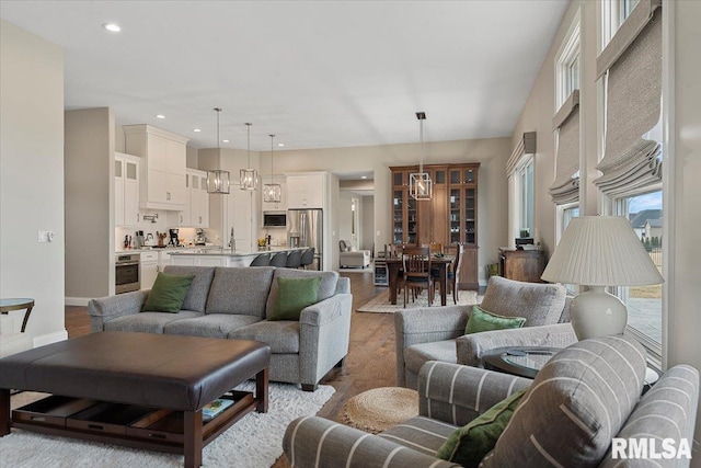 living area featuring baseboards, dark wood-style flooring, and recessed lighting