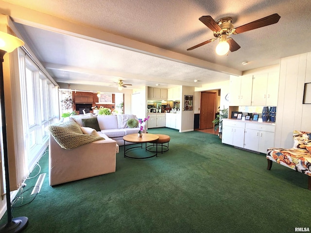 living room featuring a textured ceiling, dark colored carpet, beamed ceiling, and a ceiling fan