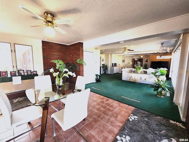 dining room with a ceiling fan, tile patterned flooring, carpet flooring, and a textured ceiling