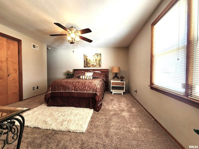 bedroom featuring a ceiling fan, baseboards, visible vents, and carpet flooring