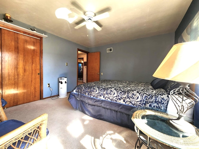 bedroom with carpet, a closet, visible vents, a ceiling fan, and baseboards