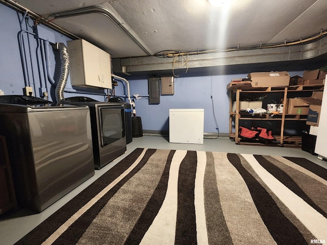 laundry area featuring separate washer and dryer, cabinet space, and electric panel