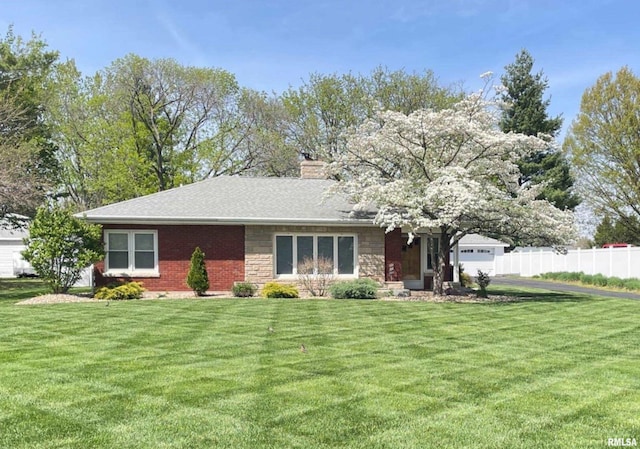 ranch-style home featuring stone siding, a chimney, fence, a front yard, and brick siding