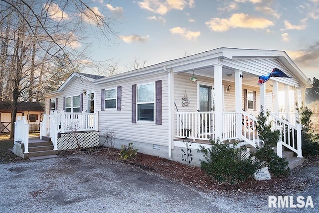 view of front facade featuring covered porch and crawl space